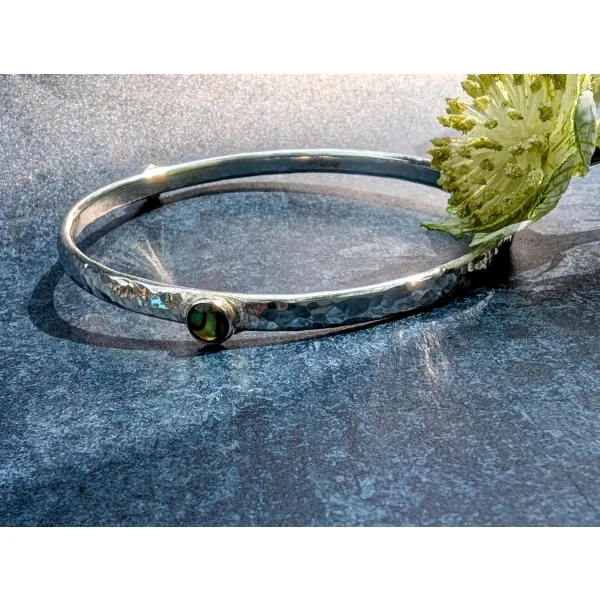 Heavy silver bangle with gemstone